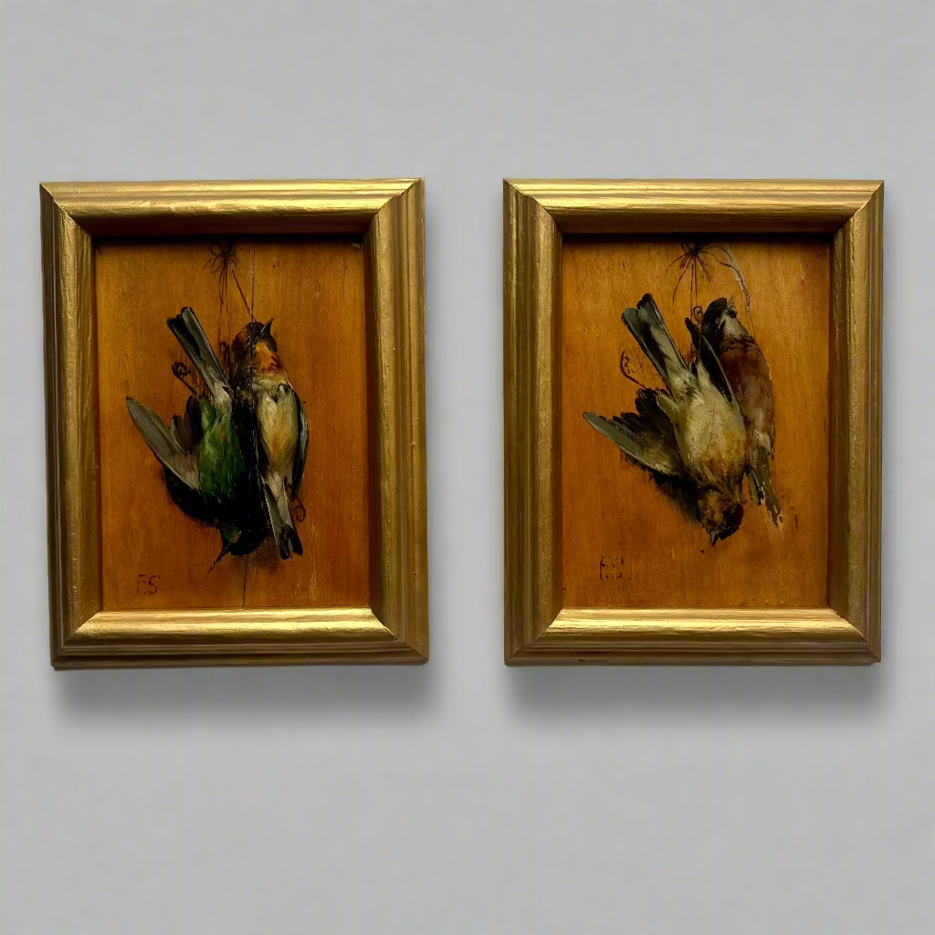 Two framed artworks of birds on a white wall