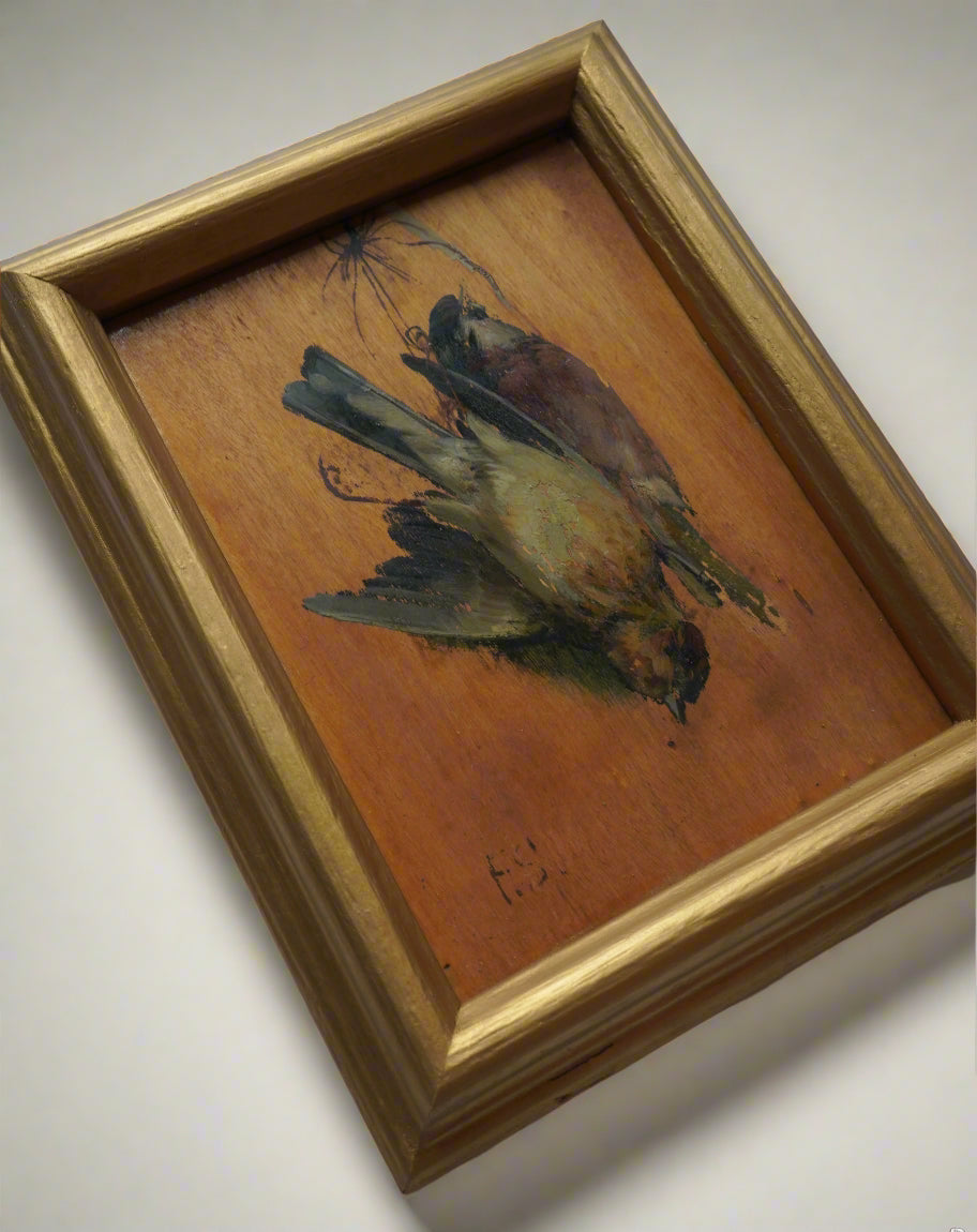 Framed painting of a bird on a textured surface with a gold frame.