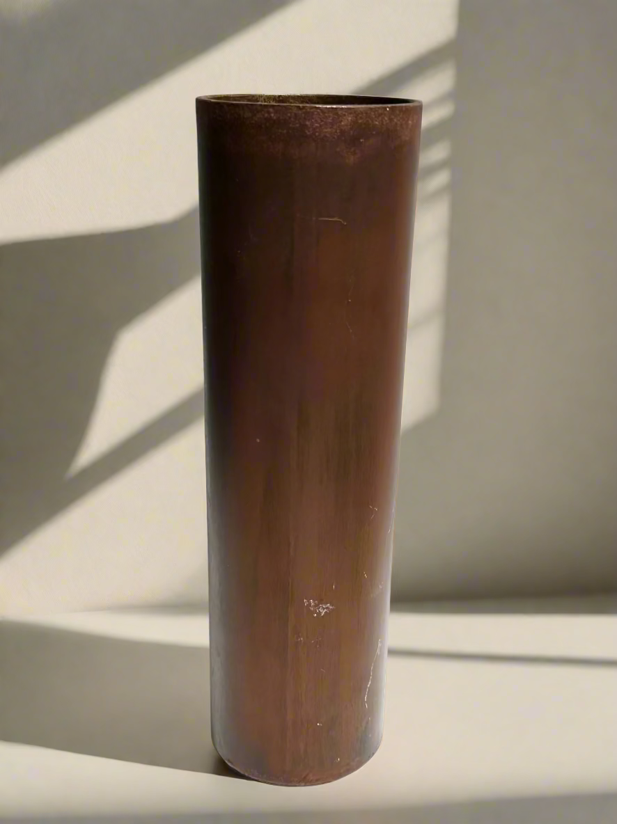 Bronze cylindrical vase on a white background
