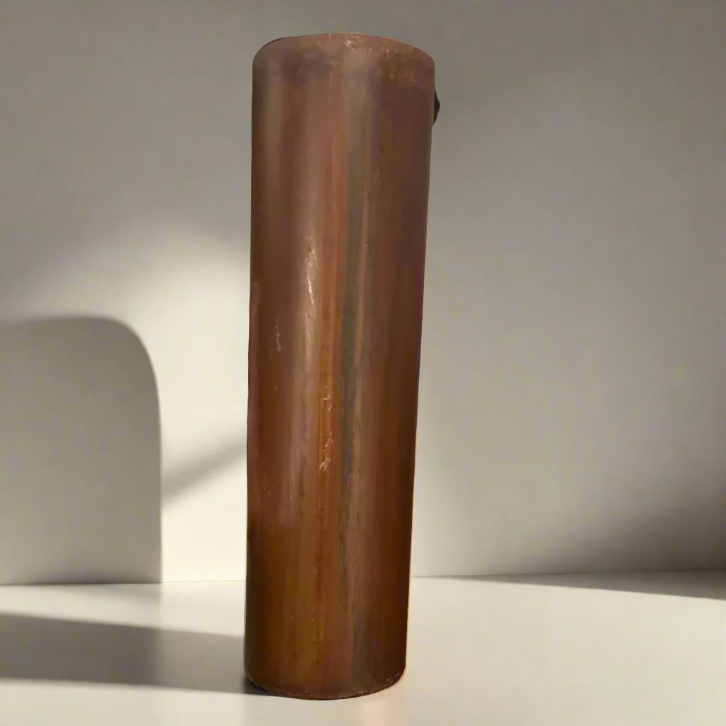 Wooden cylindrical object held by a hand