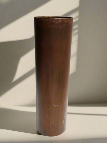 Bronze cylindrical vase on a white background